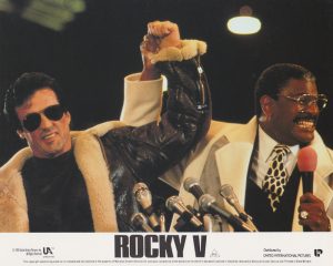 Rocky Balboa (Sylvester Stallone) alongside promoter George W. Duke (Richard Gant)