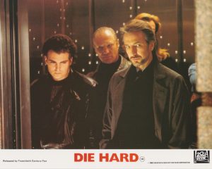 Alan Rickman as Hans Gruber with members of his terrorist gang