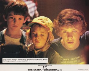 Elliott (Henry Thomas), Gertie (Drew Barrymore) and Michael (Robert MacNaughton) gaze in amazement at E.T.