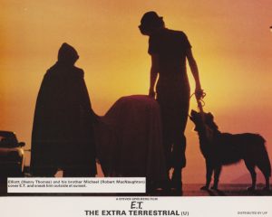 Elliott (Henry Thomas) and his brother Michael (Robert MacNaughton) cover E.T. and sneak him outside at sunset.
