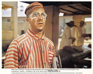 A scene from Papillon featuring Dustin Hoffman as Dega