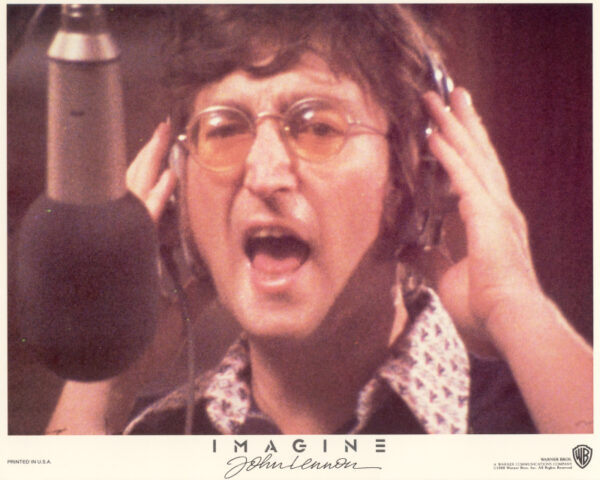 John Lennon at the microphone in a recording studio