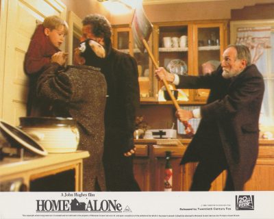 Marley (Roberts Blossom) whacks the Wet Bandits on the head with a snow shovel