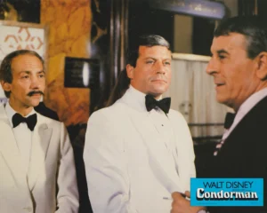 Oliver Reed (left) in a scene from "Condorman" (1981) [scanned-in image]