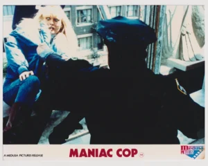 Laurene Landon in peril, courtesy of Robert Z'Dar in a scene from Maniac Cop (1988) [scanned-in image]